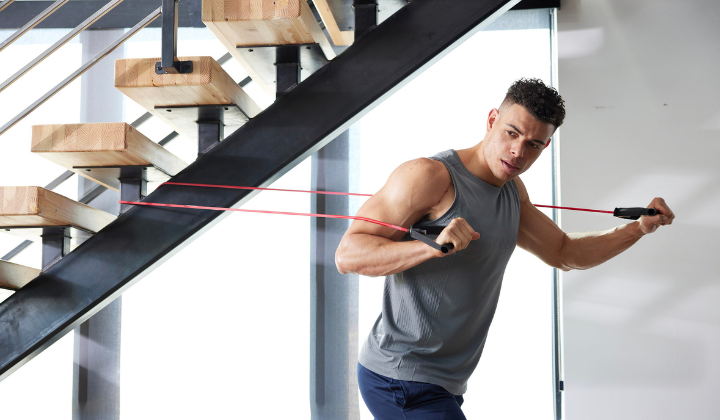 Man performing chest press with Xertube